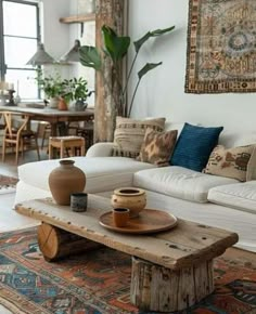 a living room filled with lots of furniture and decor on top of a wooden table