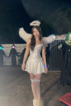 a woman in a white dress and angel wings