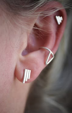 These petite stud earrings feature three joined tiny bars. They are minimalist and so easy to stack with other styles. I gave them a brushed finish. They measure about 11x5mm. Made of sterling silver. Cuff found here: https://www.etsy.com/listing/1171206293/ear-cuff-with-accent-sterling-silver CURRENT LEAD TIME ON ALL ORDERS: 2 Weeks SHIP TIME TO US: 2-7 business days SHIP TIME OUTSIDE US: Up to 8 weeks (although typically around 1-3 weeks) Modern Sterling Silver Ear Climbers For Everyday, Modern Silver Ear Climbers For Everyday, Modern Sterling Silver Ear Climbers, Handmade Minimalist Silver Ear Cuff, Minimalist Sterling Silver Diamond-shaped Earrings, Minimalist Silver Nickel-free Ear Climbers, Minimalist Nickel-free Silver Ear Climbers, Minimalist Sterling Silver Tarnish-resistant Ear Cuff, Modern Silver Tarnish-resistant Ear Cuff