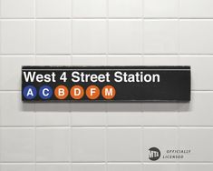 the sign for west 4 street station is on the wall