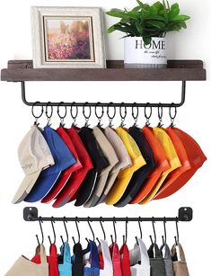 a rack with hats and purses hanging from it's sides, next to a potted plant