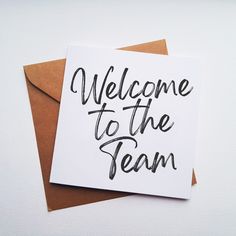 a card with the words welcome to the team written on it, in black ink