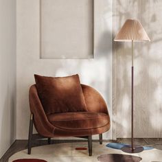 a brown chair sitting on top of a rug next to a lamp