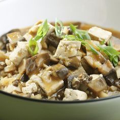 a white plate topped with mushrooms and tofu