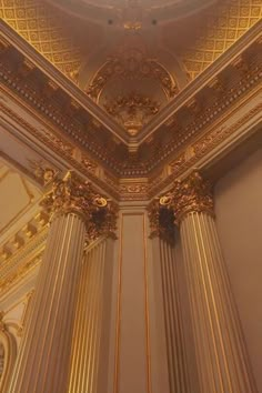 an ornate ceiling in a building with gold trim