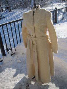 Vintage white 1980's long winter coat. Poodle, Boucle Textured, nubby weave. Size 13 / 14 US woman's clothing size.  4 large button front, 2 side pockets, sash belt with loops at seams, silk lining.  Set in sleeves. Shawl collar. Cream, ivory; winter wedding 44 inches long, neck to bottom of hem. Vintage - used; very good vintage condition. No rips; no snags. Please see pictures for details. Union made; made in USA. Dry clean only. Long Fall Wedding Outerwear, Winter Wedding Outerwear With Buttons, Cream Winter Wedding Outerwear, Long Winter Wedding Outerwear, Vintage Winter Wedding Outerwear, Vintage Wedding Outerwear With Buttons, Winter Wedding Long Coat, Winter Wedding Outerwear, Winter Wedding Coat