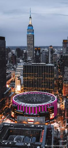 an aerial view of a large stadium in the middle of a city with tall buildings