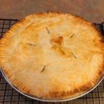 a pie sitting on top of a metal rack