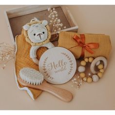 a teddy bear sitting on top of a wooden brush next to other toys and accessories