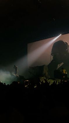 a person standing on stage in front of a crowd