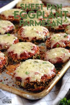 meatballs covered in sauce and parmesan cheese on a baking sheet