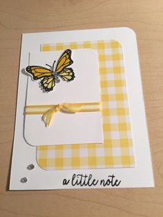 a yellow and white card with a butterfly on it