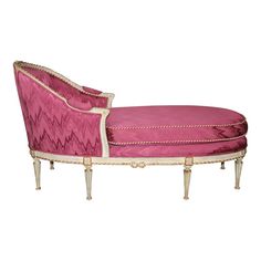 a pink and white chaise lounger with gold trimmings on the legs