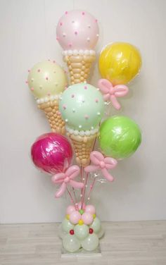 balloons in the shape of ice cream cones and bows are arranged on top of each other