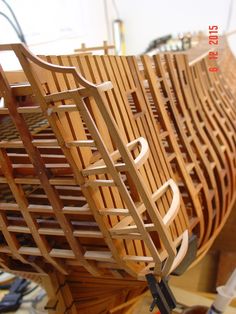 a wooden boat is being worked on in a shop