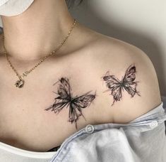 a woman's chest with two butterflies on it