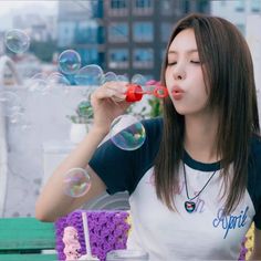 a young woman blowing bubbles on her face