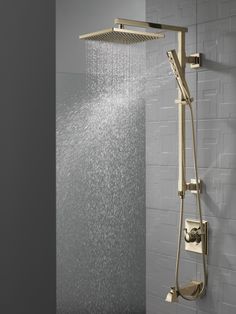 a shower head with thermostaer and hand held showerhead in front of it