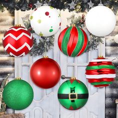 a bunch of christmas ornaments hanging on a wall