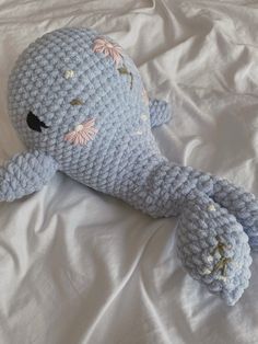 a crocheted stuffed animal laying on top of a bed