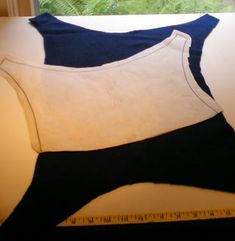 a piece of cloth is cut out to be used as a sewing pattern for a dress