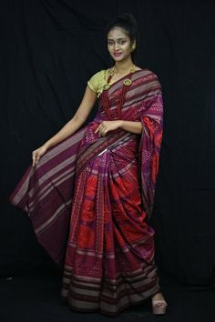 Finest pure handwoven sambalpuri ikat cotton saree with traditional motifs woven by the master weavers of Sambalpur, Odisha. It has lovely patterns and is world-famous for its gorgeous colours, texture and designs.  Specification                                                                                                                             Occasion       :- Casual Fabric               :- Sambalpuri Primary Color      :-  Purple Secondary Color  :-Maroon Material                :-Cotton Pattern               :- Motif Border Type   :-Ikkat Border Size       :-Medium Blouse Piece        :-Included Care               :- Dry Clean   Disclaimer : This is a genuine handwoven piece, It could expect unevenness in the selvedge and weave, and colours may fade or bleed due to the tradition Multicolor Ikat Print Pre-draped Saree For Navratri, Navratri Ikat Print Pre-draped Saree, Multicolor Cotton Pre-draped Saree For Festive Occasions, Traditional Ikat Print Pre-draped Saree For Festivals, Cotton Bandhani Print Saree For Festivals, Bollywood Style Saree Blouse With Ikat Print, Traditional Multicolor Cotton Pre-draped Saree, Festive Cotton Bandhani Pre-draped Saree, Navratri Ikat Print Saree Blouse Piece