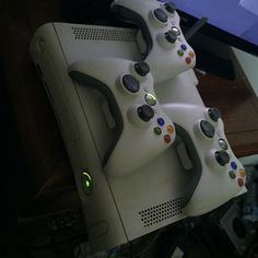 two video game controllers sitting next to each other