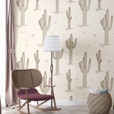 a room with cactus wallpaper and a rocking chair in front of a lamp on the floor