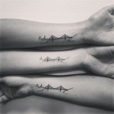 two people with matching tattoos on their arms