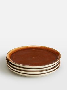 four brown plates stacked on top of each other