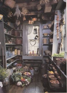 an old fashioned kitchen with lots of pots and pans