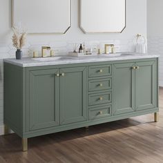 two mirrors are above the double sink vanity in this white and green bathroom with wood flooring