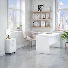 an office with a desk, chair and shelves in front of large windows overlooking the city