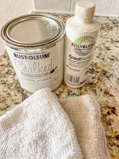 a can of paint next to a white towel on a counter