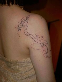 a woman with a tattoo on her shoulder