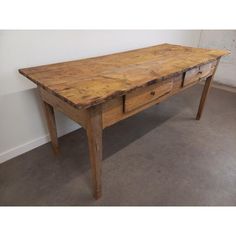 an old wooden table with two drawers