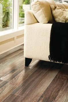 a white couch sitting on top of a wooden floor