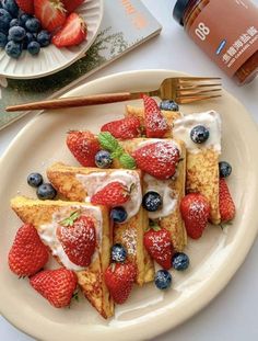 french toast with strawberries and blueberries on a plate