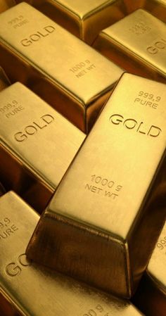 gold bars stacked on top of each other with the word gold written on them in cursive font