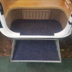 the back end of a vehicle with carpet on it