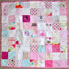 a pink and white patchwork baby quilt