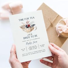 two hands holding up a card that says time for tea and the bride to be