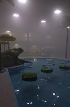 an indoor swimming pool with water slides and palm trees in the fog at night time