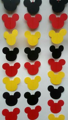 mickey mouse cut outs are arranged on a white background with red, yellow and black ones