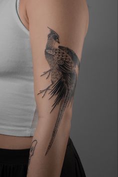 a woman with a bird tattoo on her arm