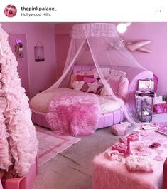 a bedroom decorated in pink and white with a canopy bed