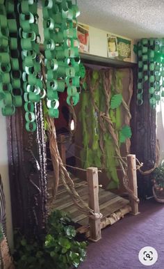 a room decorated in green and purple for st patrick's day with paper decorations