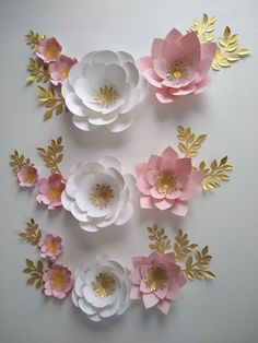 paper flowers are arranged in a circle on the wall