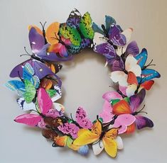 a wreath made out of colorful butterflies on a table