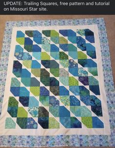 a blue and green quilt on the floor with text overlay that reads update training squares, free pattern and tutor